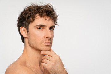 Fototapeta premium Beauty, skincare and portrait of man in studio for salon, grooming dermatology. Cosmetics, glow and self care with person and facial on white background for hydration, hygiene and shine, copy space