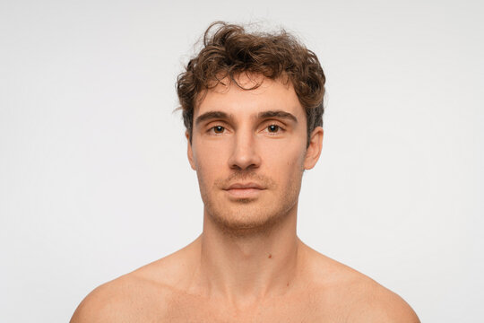 Shampoo, cosmetics and aesthetic with person on background for texture and spa treatment. Beauty, face and self care with portrait of man in studio for cleaning, salon grooming and hairstyle.