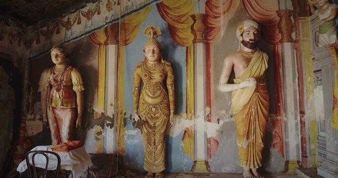 Elegant Statues Surrounded by Stunning Temple Mural Works