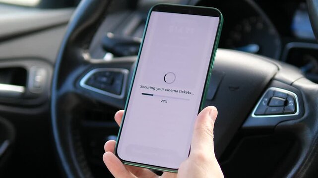 Purchasing a premium cinema ticket on a phone inside a car. Showcases fast paperless ticketing and secure mobile payments on the go. Great for lifestyle, entertainment, and technology-driven service