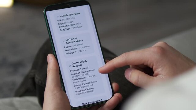 Checking official vehicle history report on smartphone. Close-up of VIN, mileage, and accident records. Essential footage for automotive marketplaces, car insurance, and digital verification service