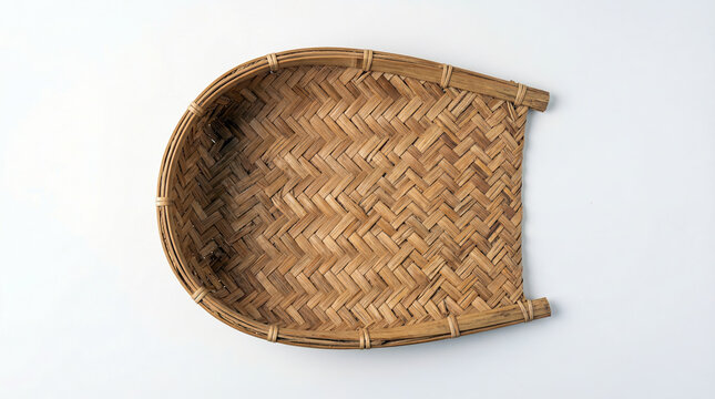 Empty traditional bamboo woven rice winnowing basket on a white background.