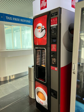 Modern Illy coffee vending machines in an airport lounge. Riga, Latvia - April 5, 2026. Offering premium espresso, cappuccino, and automated beverage service.