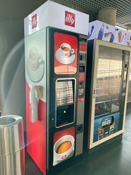 Modern Illy coffee vending machines in an airport lounge. Riga, Latvia - April 5, 2026. Offering premium espresso, cappuccino, and automated beverage service.