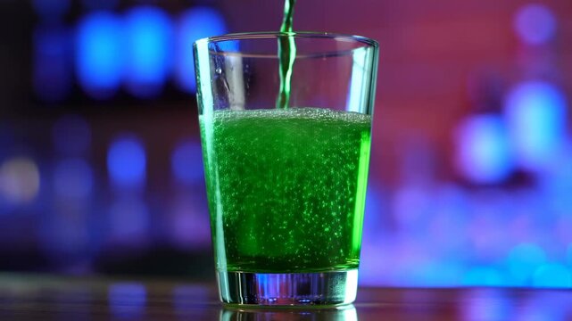 Effervescent Green Cocktail Poured Into Glass Amidst Vibrant Nightclub Ambiance And Lively Energy
