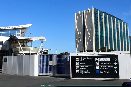 Auckland, NZ - March 4. 2026: Directional signage for transport services at the Auckland Airport, including buses, drop-off/pick-up, valet, car rentals and terminal transfer buses. Editorial Use Only.