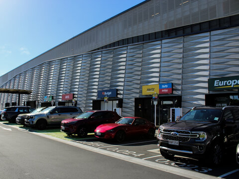 Auckland, NZ - March 4. 2026: A modern building at the Auckland Airport with several popular rental car companies. Editorial Use Only.