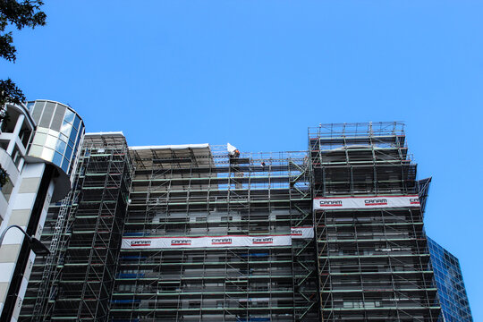 Auckland, New Zealand - Mar 4, 2026: A multi-story building surrounded by scaffolding during a construction or renovation project. The CANAM logo is present. Editorial Use Only.