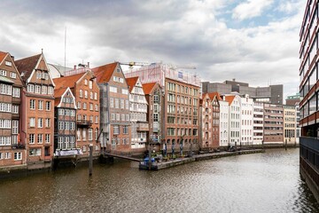 Naklejka premium Perspective view of the canal and bridge leading into the city