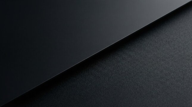 Matte black smooth surface and charcoal grainy paper texture, minimalist diagonal split background