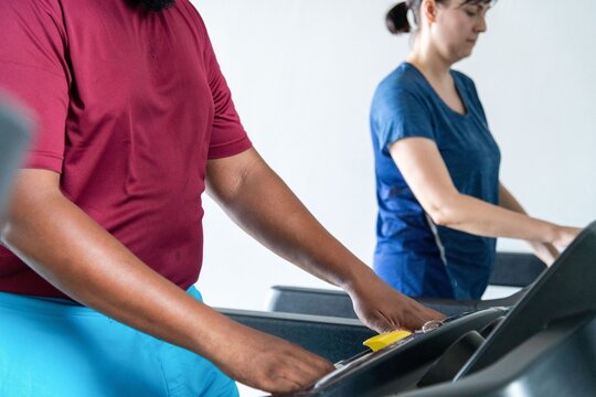 People exercising on treadmills indoors