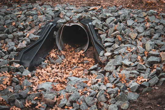 closeup of a culvert pipe, which is a structural tunnel designed to prevent stormwater from pooling on the surface and causing erosion or flooding.