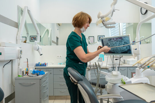 Clinical assistant cleaning dental office and checking equipment before appointment. Professional staff organizing medical tools and sterilization for healthcare service.