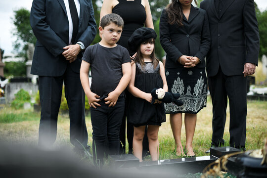 Somber gathering at outdoor ceremony.