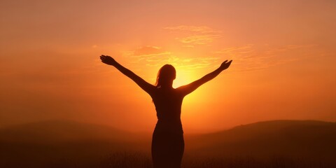 Fototapeta premium The silhouetted person embracing a golden sunset over rolling peaceful hills at dusk