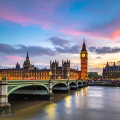 Fototapeta premium A beautiful dusk scene showcases a historic clock tower and parliament buildings, reflected in the river below a vibrant sky