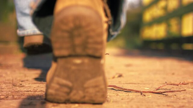 Foot in boots jumps on wooden bridge