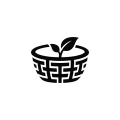 Fototapeta premium Black and white silhouette of a basket with a leaf sprouting from it