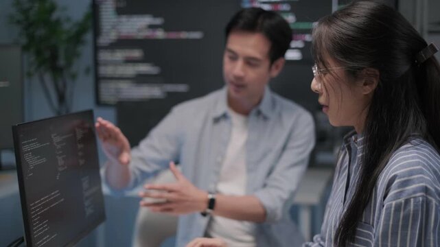Programmer software engineer developer coding working together indoor office workplace tech project support laptop computer desktop monitor, business teamwork discussion brainstorming concept