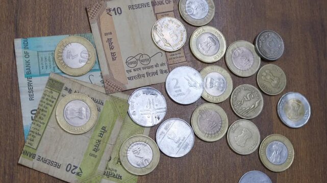 Overhead View of Indian Currency Coins and Banknotes on Wooden Table