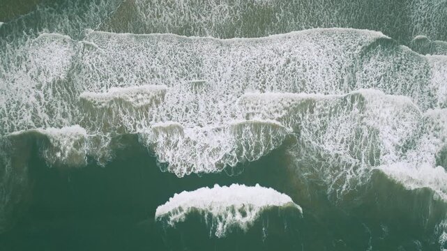 Abstract drone view of breaking Atlantic waves near Ingleses