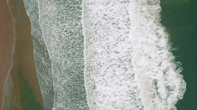 Vertical shoreline wave bands at Ingleses Beach from above