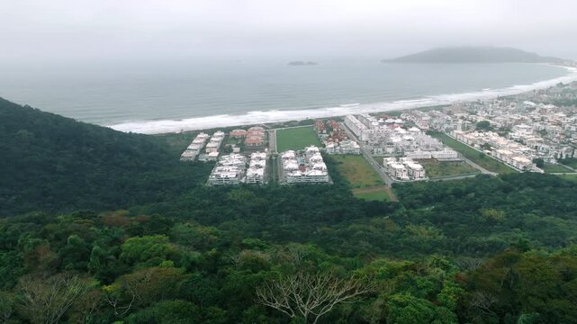 Wide aerial of Ingleses coast with forest, town and beach