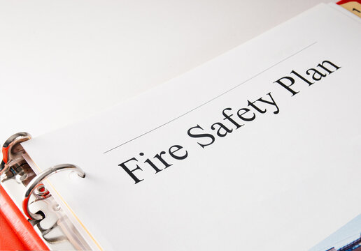 Fire safety plan for building. Cover Page in binder with emergency instructions, equipment location and contacts. Required for residential and commercial buildings in BC Canada. Selective focus.