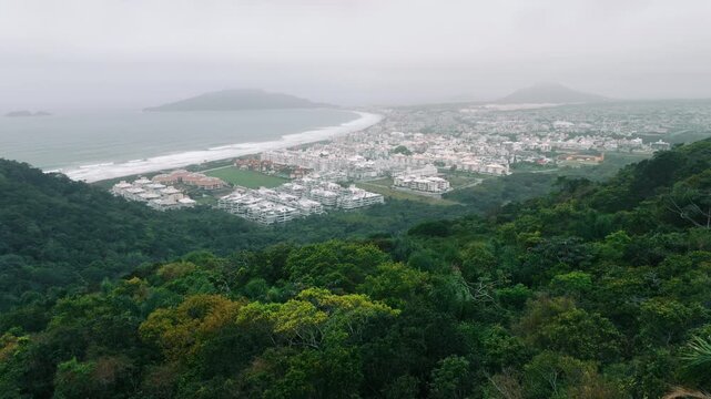 Panoramic aerial of Ingleses between forested hills and sea