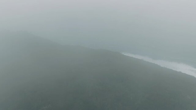 Misty forest ridge descending to the ocean in Florianopolis