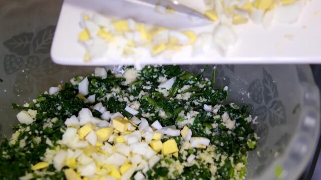 Spring radish and eggs salad. Fresh Easter salad with boiled eggs, cornsalad lettuce and radish. Stock footage video 4k