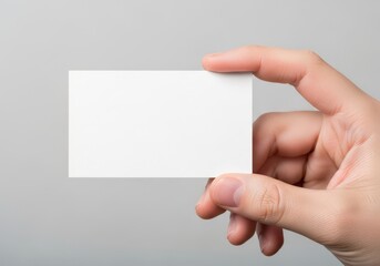 Fototapeta premium A hand holding a blank white business card template for professional branding and design mockup