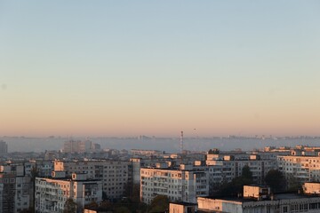 Fototapeta premium Urban Sunrise Panoramic View of City Buildings and Misty Horizon at Dawn. Serenity.
