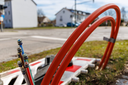 Fiber optic cables installation for high-speed broadband network in residential area, infrastructure expansion at construction site, modern telecommunications technology