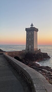 Petit Minou lighthouse lighthouse on rocky coast with with ocean waves in Le Conquet Brittany France scenic seascape