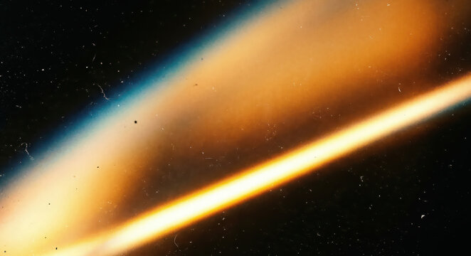Cinematic cosmic light leak beam with film scratches on black background, vintage texture effect