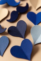 Obraz premium Close Up Of Blue And White Hearts And Mustaches Shapes Scattered On A Tan Background With Soft Lighting And Shallow Depth Of Field Perfect For Fathers Day Celebration