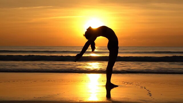 Woman performing yoga backbend pose on tropical beach at sunset