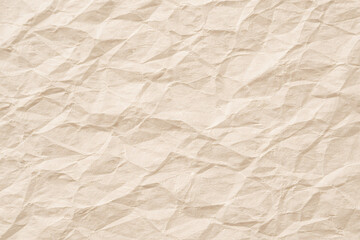 Obraz premium Light brown crumpled kraft paper texture background. Wrinkled beige recycled cardboard page surface for eco vintage design