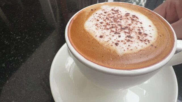 Closeup of Serving a Cappuccino Coffee Drink in a Cup