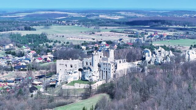 Aerial Poland Zamek Ogrodzieniec castle mountain pull 2. Ruins of medieval castle south Poland. Original stronghold from 11th century, stone castle built in13th century. Rocky mountain top.