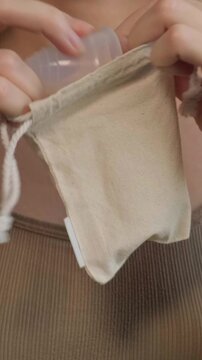 Sustainable Menstrual Product Handling. Women Managing Menstrual Cups Discreetly In Travel Containers. Ensuring Discreet And Ecoconscious Storage Of Menstrual Cups During Travel Routines
