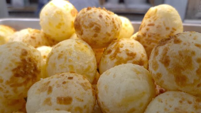 Closeup of steaming cheese puffs showing their texture and crispness.