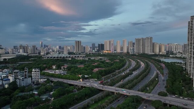Wide aerial shot of intersecting roads and Thang Long Boulevard in Hanoi with expansive skyline, green spaces, and layered urban development under evening sky