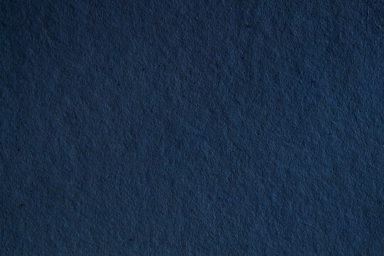 Dark navy blue paper texture background. Rough blank canvas sheet surface for elegant luxury graphic design or night sky concept