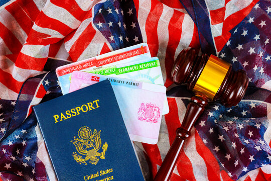 Documents related to United States citizenship immigration lay on an American flag with court gavel nearby.