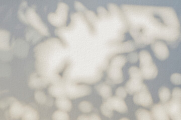 Leaf shadow and light beige background. Nature tropical leaves plant and tree branch shade with...
