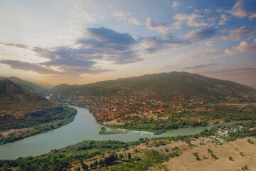 Georgia. Aerial view of Mtzkheta. Old city, river and sky with clouds © artmim