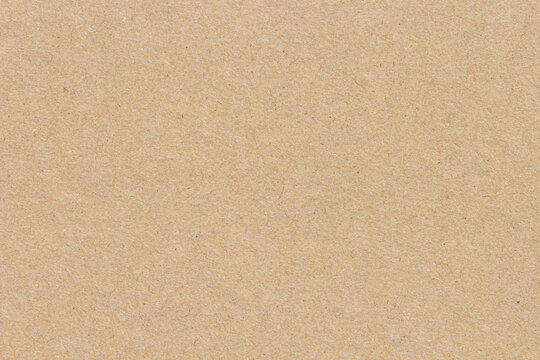 Smooth brown cardboard paper texture background. Blank recycled kraft sheet surface for rustic eco friendly packaging design