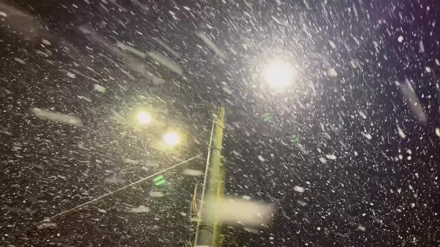 A snowstorm and snowfall on the evening streets of the city. The city is buried in snow. Ternopil, Ukraine, 